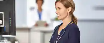 nurse looking at computer